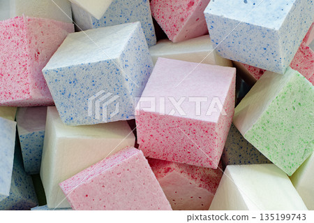 A lot of cubic pieces of multi-colored foam rubber 135199743
