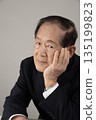 Bust enhancement of a senior man resting his chin on his hand 135199823