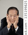 Bust enhancement of a senior man resting his chin on his hand 135199825