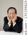 Bust enhancement of a senior man resting his chin on his hand 135199829