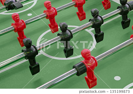Kicker or foosball, table football or soccer game, plastic figurines on a green field 135199873