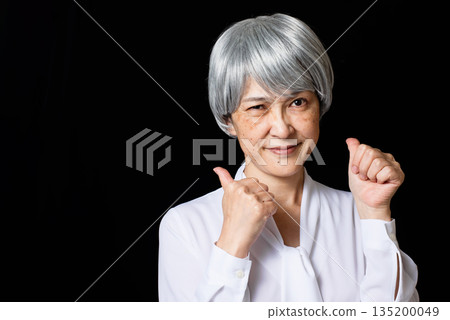 A gray-haired senior woman cheering A gray-haired senior woman cheering 135200049