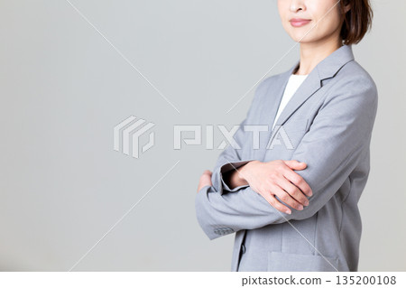 A middle-aged business woman wearing a gray suit A middle-aged business woman wearing a gray suit 135200108