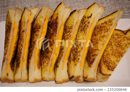 Golden, fluffy French toast with a crisp edge and soft center, topped with syrup, fruits, or powdered sugar—offering a perfect balance of sweetness, warmth, and comfort in every delightful bite. 135200646