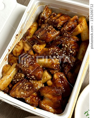 Crispy Korean fried chicken, perfectly glazed with a sweet and spicy sauce. Ideal for food photography and menus, showcasing the irresistible crunch and flavor of this beloved dish. 135200712