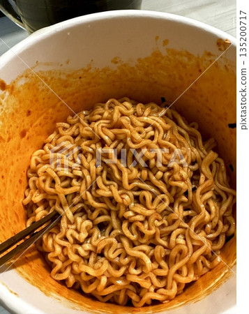 Spicy buldak ramyeon with fiery hot sauce and chewy noodles, delivering an intense, flavorful kick in every bite. A perfect choice for those who crave bold, spicy Korean comfort food. Spicy buldak ramyeon with fiery hot sauce and chewy noodles, delivering an intense, flavorful kick in every bite. A perfect choice for those who crave bold, spicy Korean comfort food. 135200717