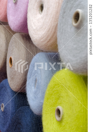 Spools of multi-colored wool threads Spools of multi-colored wool threads 135201282