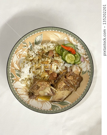 Nasi campur, a classic Indonesian dish featuring rice with an assortment of flavorful sides like fried chicken, sambal, vegetables, and tempeh. A vibrant, balanced meal celebrating Indonesian flavors. Nasi campur, a classic Indonesian dish featuring rice with an assortment of flavorful sides like fried chicken, sambal, vegetables, and tempeh. A vibrant, balanced meal celebrating Indonesian flavors. 135202201