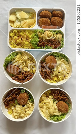 A traditional Korean dosirak, beautifully arranged with rice, assorted banchan, and savory proteins. Balanced and visually inviting, it’s a portable meal packed with vibrant flavors. 135202221