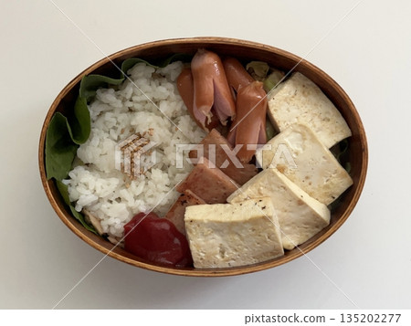 A traditional Korean dosirak, beautifully arranged with rice, assorted banchan, and savory proteins. Balanced and visually inviting, it’s a portable meal packed with vibrant flavors. A traditional Korean dosirak, beautifully arranged with rice, assorted banchan, and savory proteins. Balanced and visually inviting, it’s a portable meal packed with vibrant flavors. 135202277