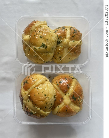 Korean garlic bread, a soft bun filled with creamy garlic butter and cream cheese, baked to golden perfection. A savory and slightly sweet treat with a rich, aromatic flavor. Korean garlic bread, a soft bun filled with creamy garlic butter and cream cheese, baked to golden perfection. A savory and slightly sweet treat with a rich, aromatic flavor. 135202373