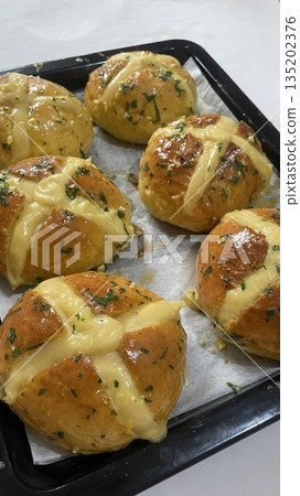 Korean garlic bread, a soft bun filled with creamy garlic butter and cream cheese, baked to golden perfection. A savory and slightly sweet treat with a rich, aromatic flavor. Korean garlic bread, a soft bun filled with creamy garlic butter and cream cheese, baked to golden perfection. A savory and slightly sweet treat with a rich, aromatic flavor. 135202376