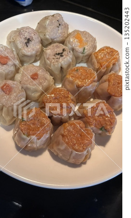Shumai shrimp with sauce, Steamed shrimp dumplings dim or dim sum and vegetable on wooden table, Cantonese Dimsum food cuisine for breakfast, Chinese traditional food. Shumai shrimp with sauce, Steamed shrimp dumplings dim or dim sum and vegetable on wooden table, Cantonese Dimsum food cuisine for breakfast, Chinese traditional food. 135202443