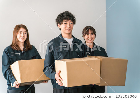Male and female transportation, logistics, courier, distribution, delivery, and delivery company workers holding cardboard boxes 135203006