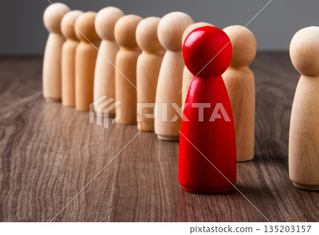 Red wooden peg leading diverse business team Red wooden peg leading diverse business team 135203157