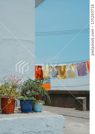 Korean Alleyway Scene with Colorful Laundry and Potted Plants Korean Alleyway Scene with Colorful Laundry and Potted Plants 135203718