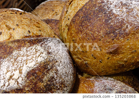 Group of traditional round loaves of dark rye bread Group of traditional round loaves of dark rye bread 135203868