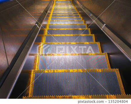 Scenery of the steps of a descending escalator 135204804