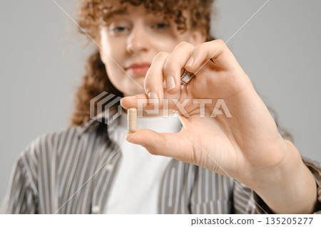 Close up view of female hand with vitamin Close up view of female hand with vitamin 135205277