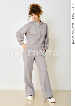 Casual indoor outfit showcase featuring a model in comfortable loungewear apparel 135205316