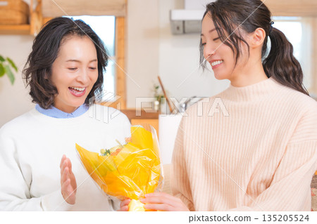 Daughter giving a present to her mother 135205524