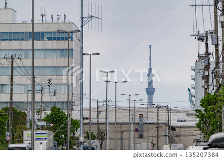 Tokyo Skytree and street lights lining the street, a typical urban scene 135207384