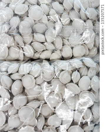 Frozen dumplings packaged in plastic bags for easy cooking. Frozen dumplings packaged in plastic bags for easy cooking. 135207571