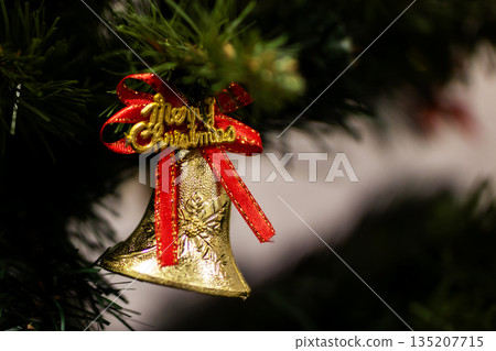Festive holiday decoration, Sparkling holiday bell adorned with greenery and cheerful lettering Festive holiday decoration, Sparkling holiday bell adorned with greenery and cheerful lettering 135207715