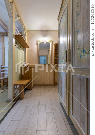 Rustic hallway with hand-painted floral wardrobe and wooden furniture Rustic hallway with hand-painted floral wardrobe and wooden furniture 135208510