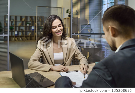 Bank consulting as business client signs contract with financial manager in office Bank consulting as business client signs contract with financial manager in office 135208655