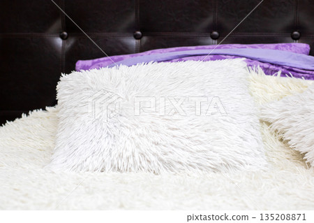 Soft textures and warm lighting, Modern bedroom with plush pillow and elegant accents Soft textures and warm lighting, Modern bedroom with plush pillow and elegant accents 135208871