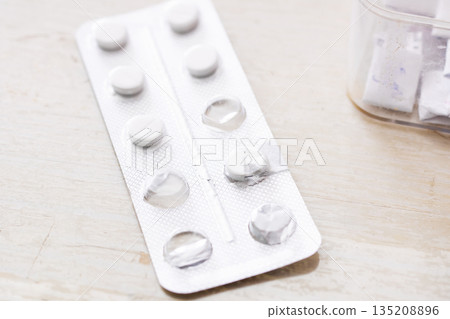 Medical environment showing prescription containers and organized pills for adherence 135208896