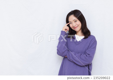 Woman thinking with a smile 135209022