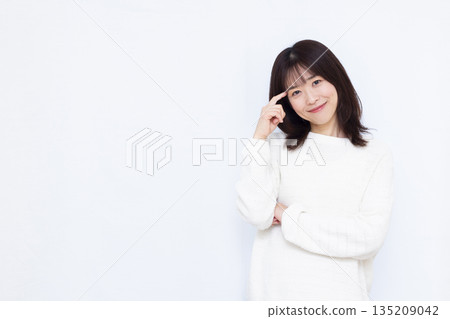 Woman thinking with a smile 135209042