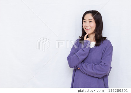 Woman thinking with a smile Woman thinking with a smile 135209291