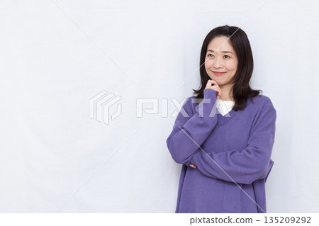 Woman thinking with a smile 135209292