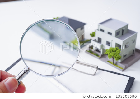 Real estate documents and a magnifying glass Real estate documents and a magnifying glass 135209590