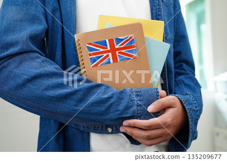 Learning English, Asian teenage student holding book with flag for language program education. 135209677