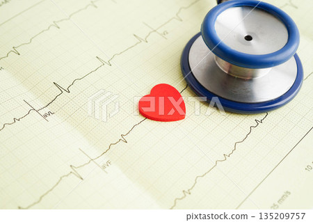 Stethoscope on electrocardiogram ECG, heart wave, heart attack, cardiogram report. Stethoscope on electrocardiogram ECG, heart wave, heart attack, cardiogram report. 135209757
