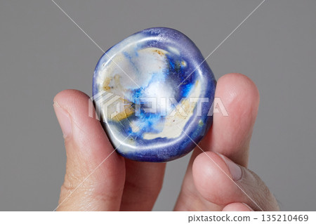 worry stone healing on gray background worry stone healing on gray background 135210469