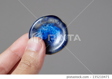 worry stone healing on gray background 135210471