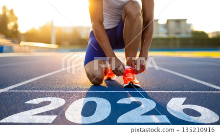 Athlete Preparing for Race with Focus on 2026 in Sunset Glare 135210916