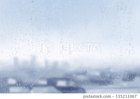 Rainy Day Window View with Blurred City Background 135211067
