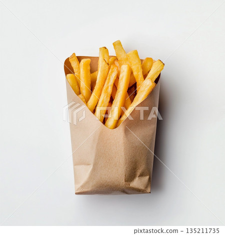 A brown paper bag filled with golden, crispy French fries is shown against a white background. A brown paper bag filled with golden, crispy French fries is shown against a white background. 135211735