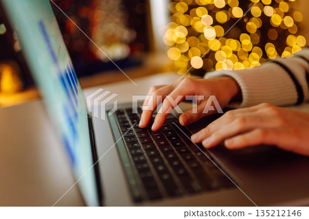Close-up of hands working on a laptop keyboard. Freelance, online course. Shopping online. Close-up of hands working on a laptop keyboard. Freelance, online course. Shopping online. 135212146