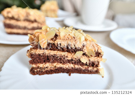 A slice of homemade almond cake on the table 135212324