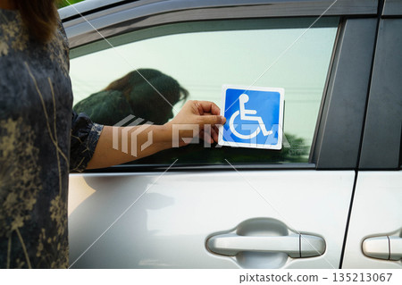 Wheelchair sticker sign on car for safety travel. 135213067