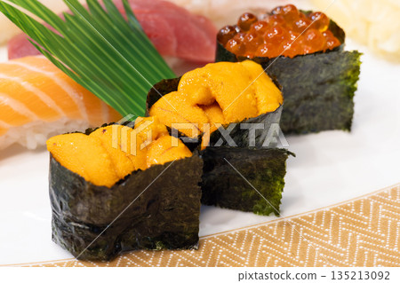 Delicious Hokkaido nigiri sushi including gunkanmaki rolls with sea urchin and salmon roe Delicious Hokkaido nigiri sushi including gunkanmaki rolls with sea urchin and salmon roe 135213092