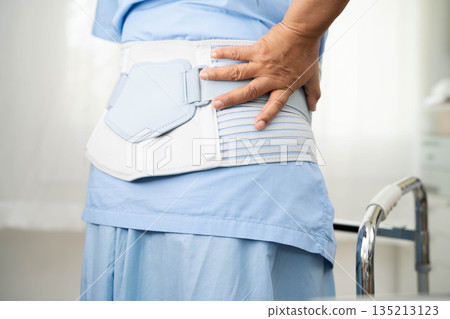 Asian senior pain back wearing elastic support belt with walker. Asian senior pain back wearing elastic support belt with walker. 135213123