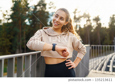 Young woman in sportswear is training outdoors. Sports concept, healthy body. Young woman in sportswear is training outdoors. Sports concept, healthy body. 135213611
